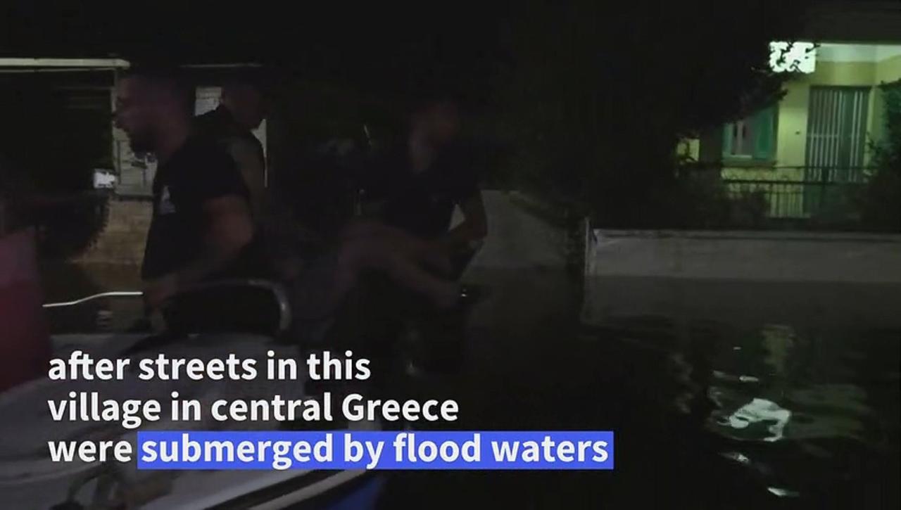 People rescued by boat in flooded village in central Greece