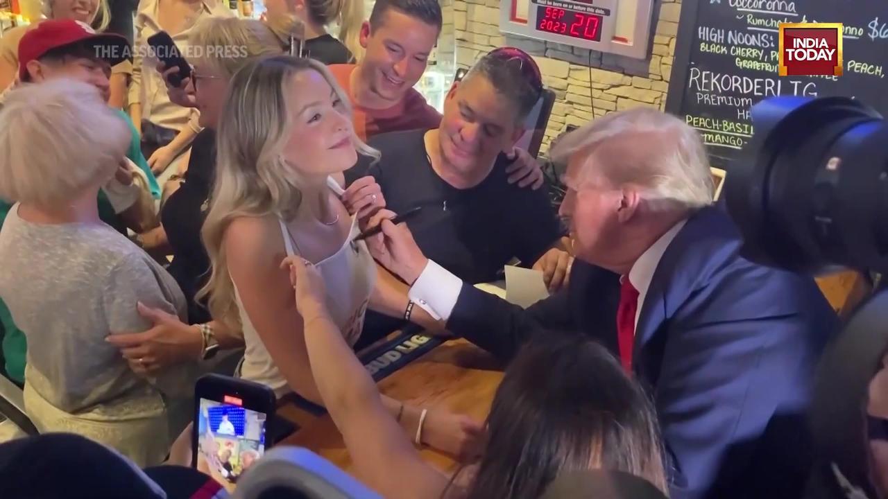 Donald Trump Autographs Woman's Tank Top During Campaign Trip In Iowa