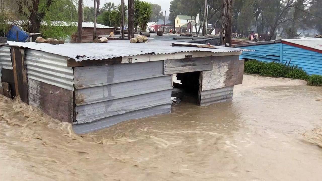 Burst river banks and flooded homes after heavy rainfall in Cape Town area
