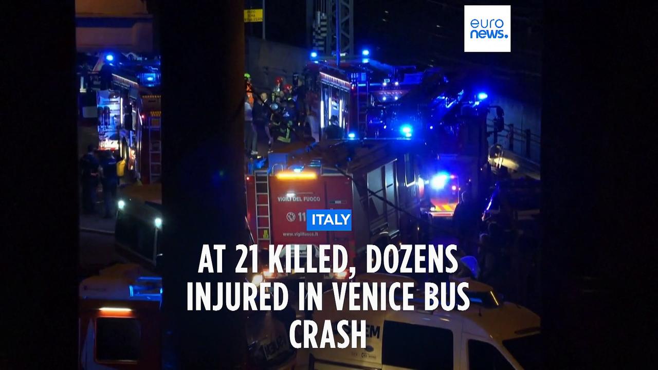 Reports of a number of fatalities after a bus plunges off bridge in Venice, lands on train tracks