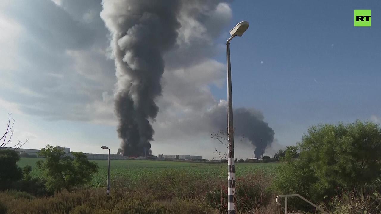 Clouds of smoke rise after rockets from Gaza hit buildings in Rehovot, Israel