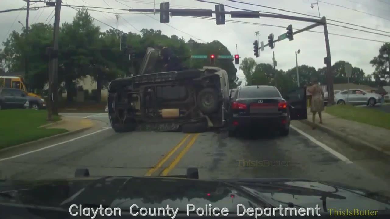 Clayton County police dashcam shows roll over crash, officer helping the driver out of the vehicle