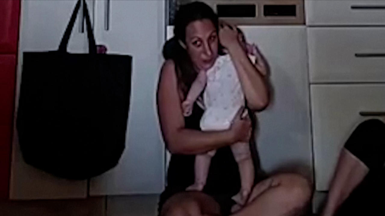 Israeli woman clutches her baby as Hamas militants take husband hostage