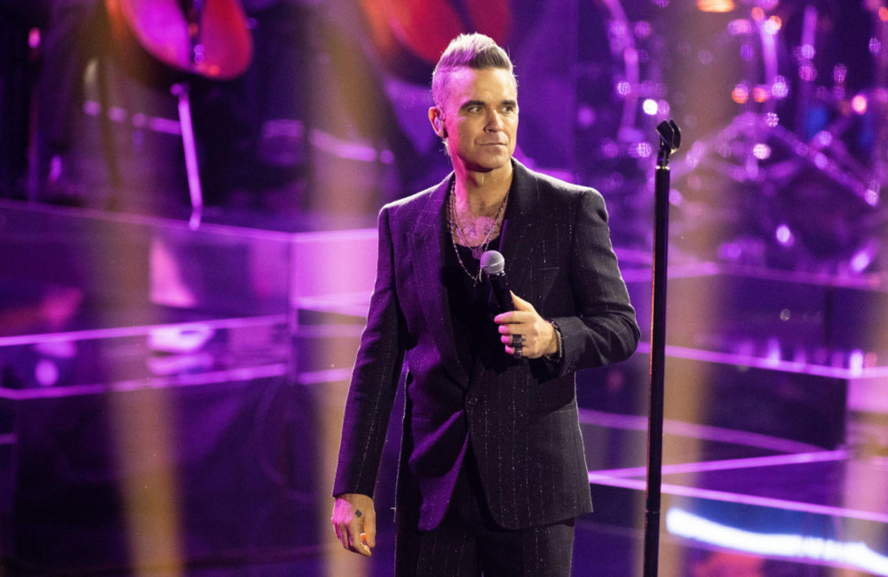 Robbie Williams dedicates emotional Angels performance to fan who died at his concert: 'I think she deserves a big song'