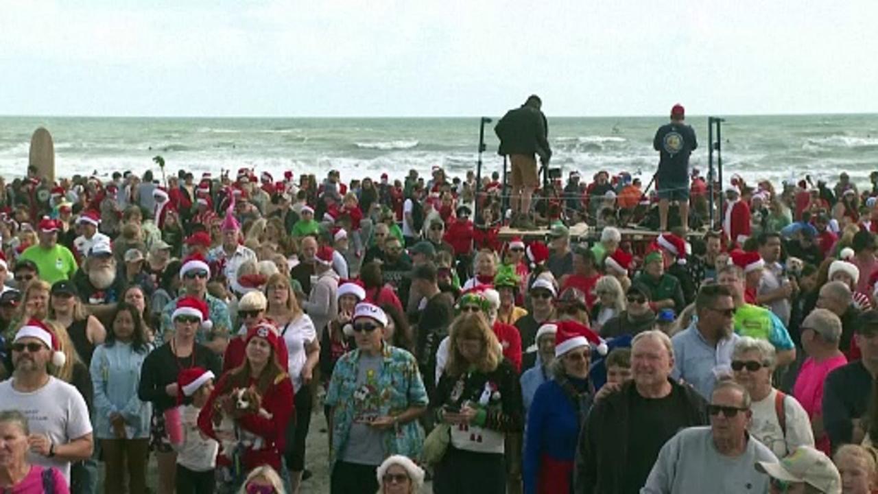 Surfing Santas ride waves, raise funds in Florida