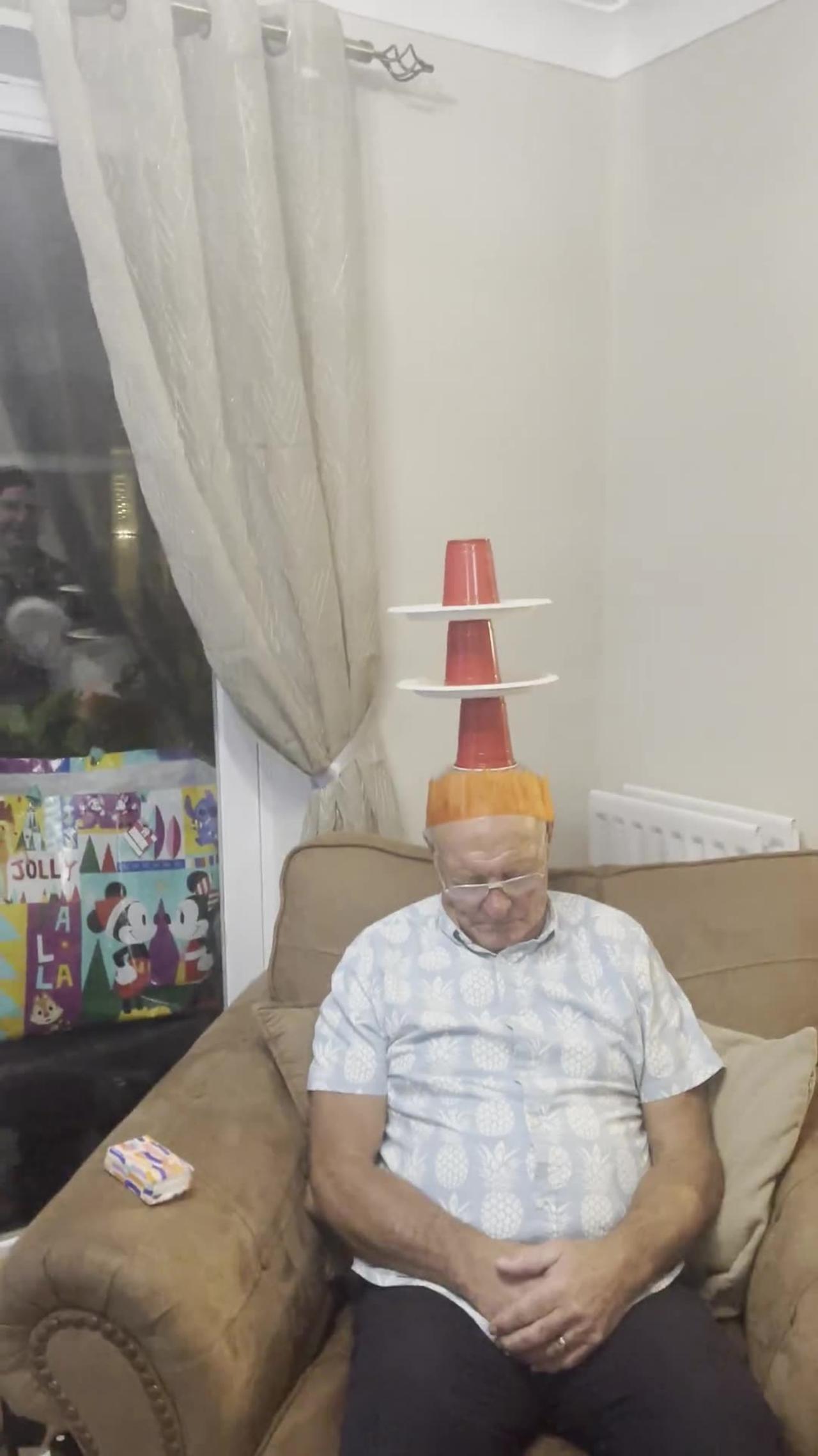 Family Plays a Game on Sleeping Grandpa