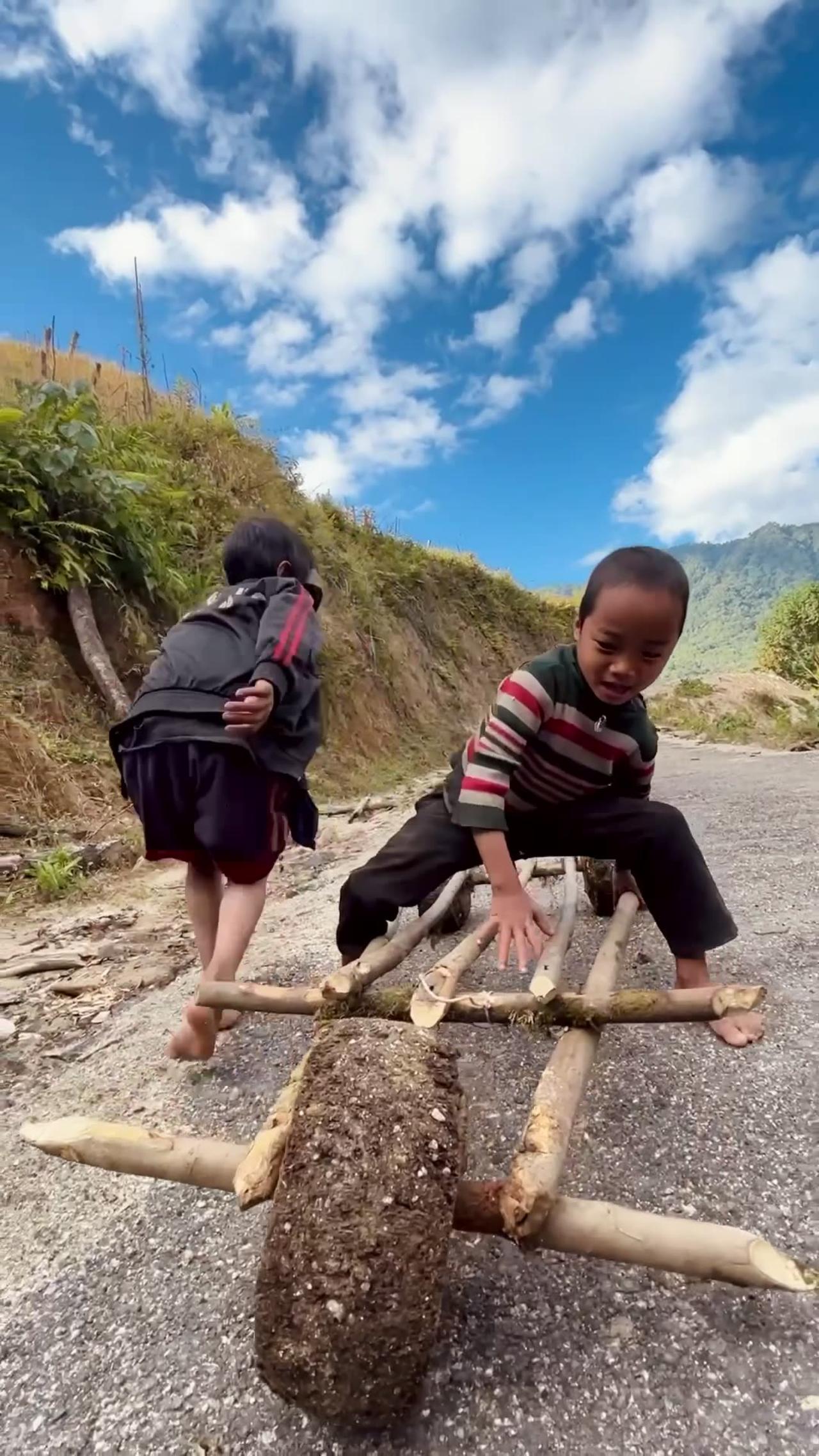 Children Play On Homemade Wood Vehicle