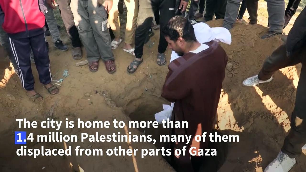 Gazans pull dead boy from the rubble after Israeli strike on Rafah