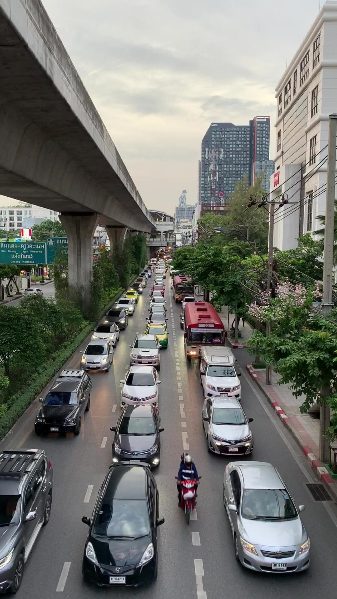 stock footage traffic road in middle of the city with high rise buildings under the bridge