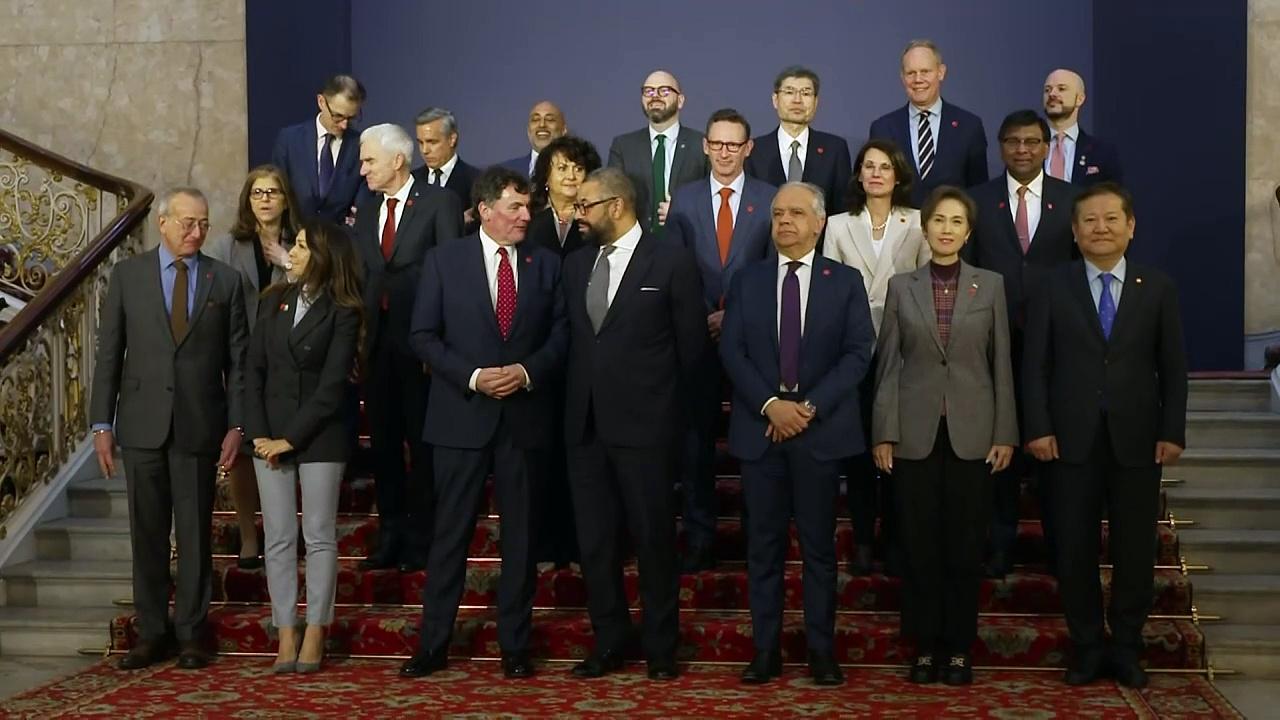 Delegates pose for family photo at Global Fraud Summit