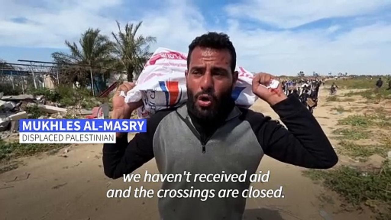 Palestinians rush for aid airdropped in the northern Gaza Strip
