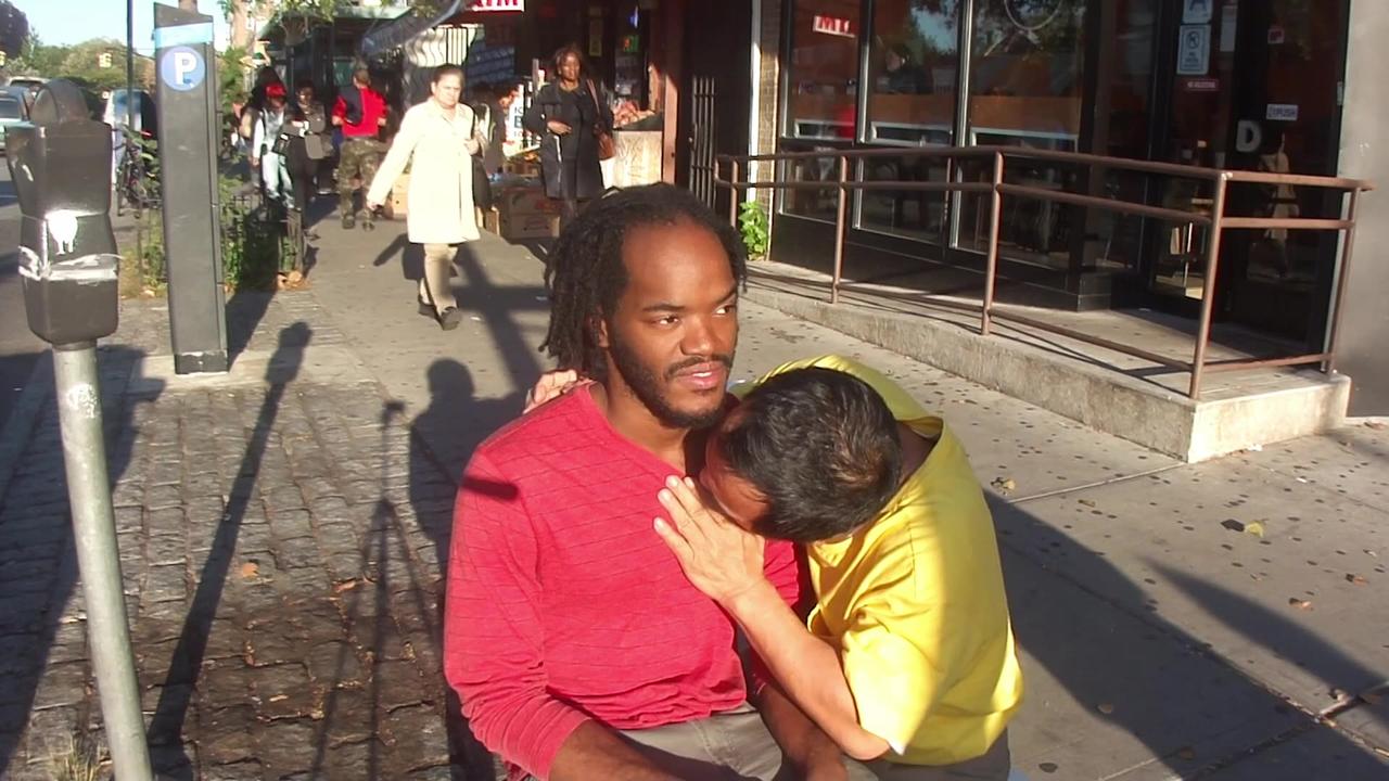 Luodong Massages Black Man On Sidewalk
