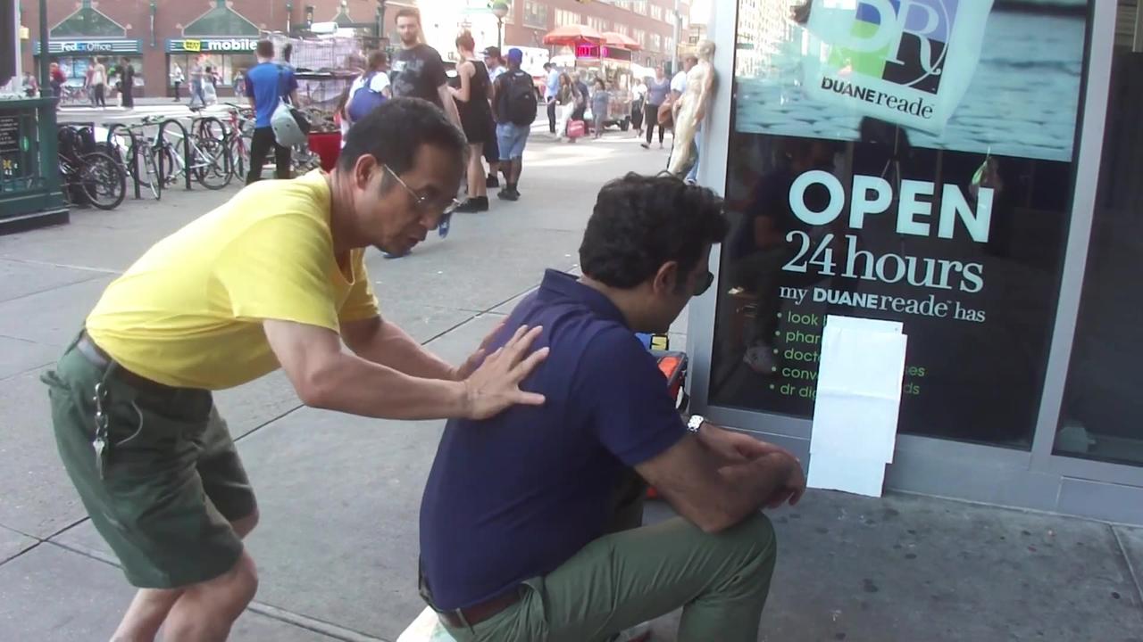 Luodong Massages Man In Purple Shirt On Sidewalk