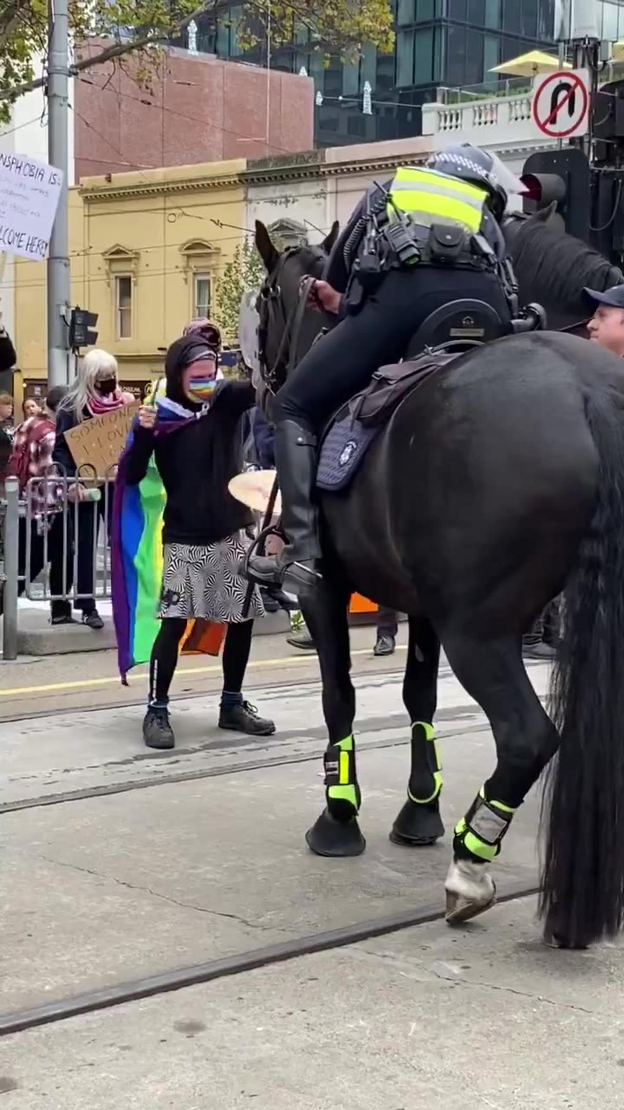Nut job wearing LGBTQ flag tries to scare horse