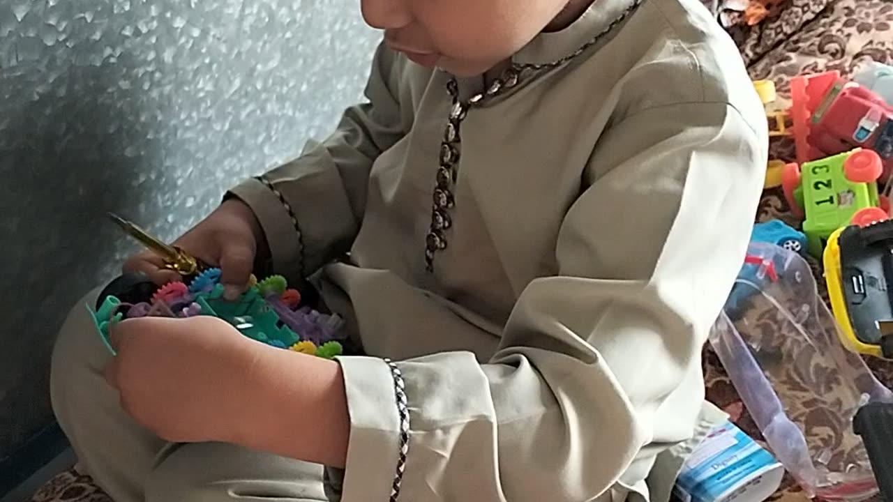 Abdullah is repairing his toys