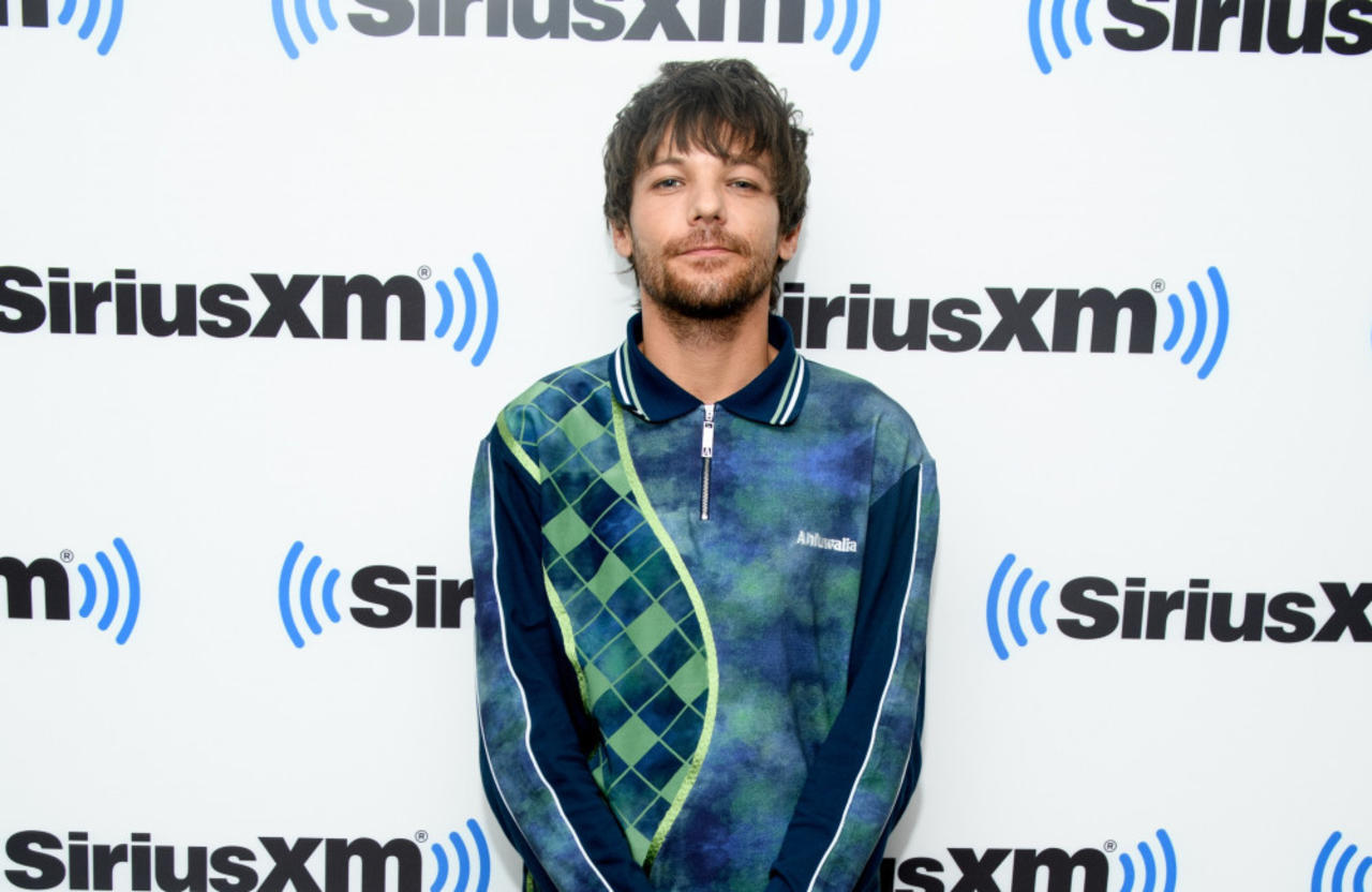 Louis Tomlinson no longer feels like he's in competition with his former One Direction bandmates