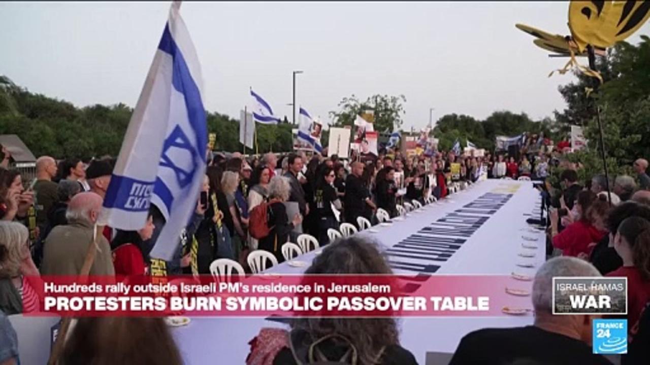 Irael protesters burn symbolic seder table as hundreds rally outside PM's residence