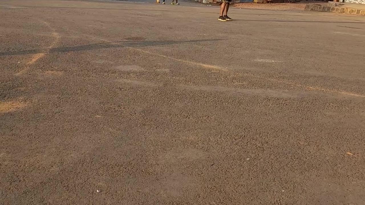 A random guy playing football on the street