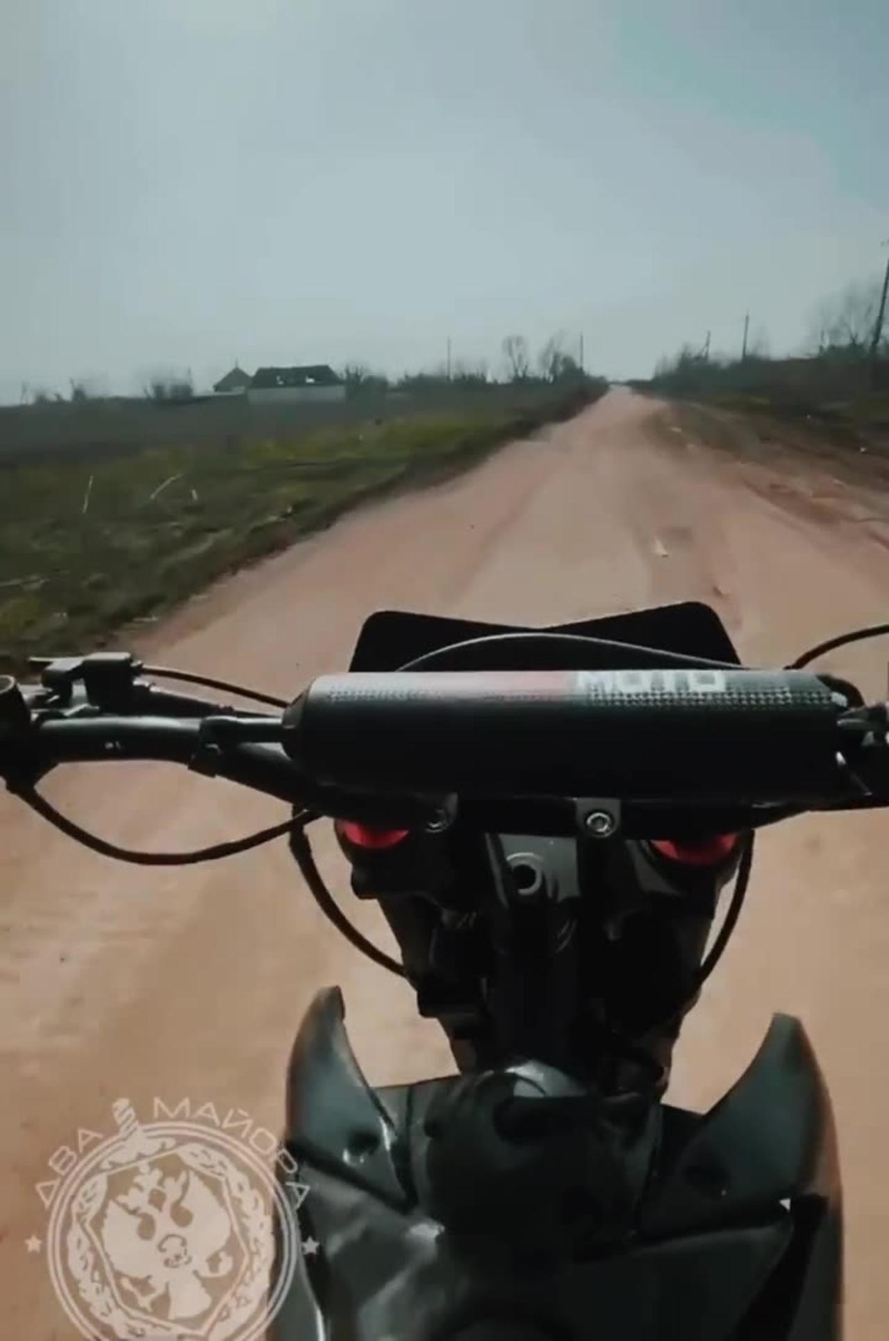 Russian soldier on a motorcycle records a Russian SU-25 flying low