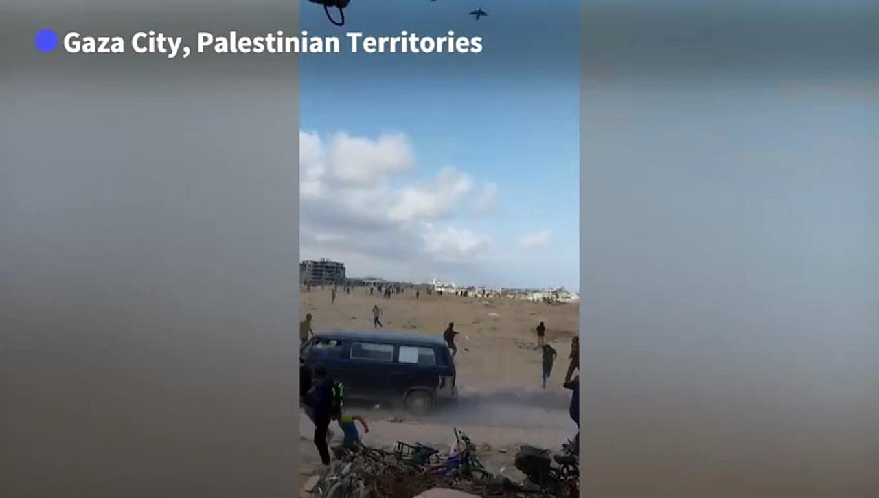 Gazans rush towards airdropped humanitarian aid amid Israel-Hamas war