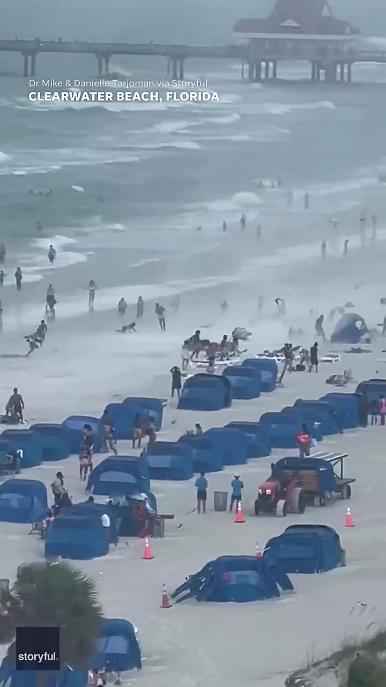 Footage captures waterspout ripping through crowded beach #Shorts