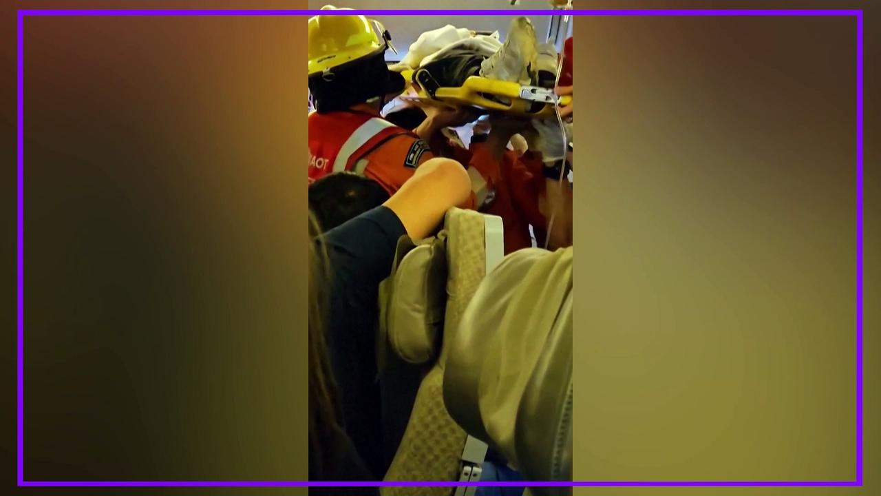 Passenger carried on stretcher from Singapore Airlines flight after turbulence which caused fatality and 30 injuries