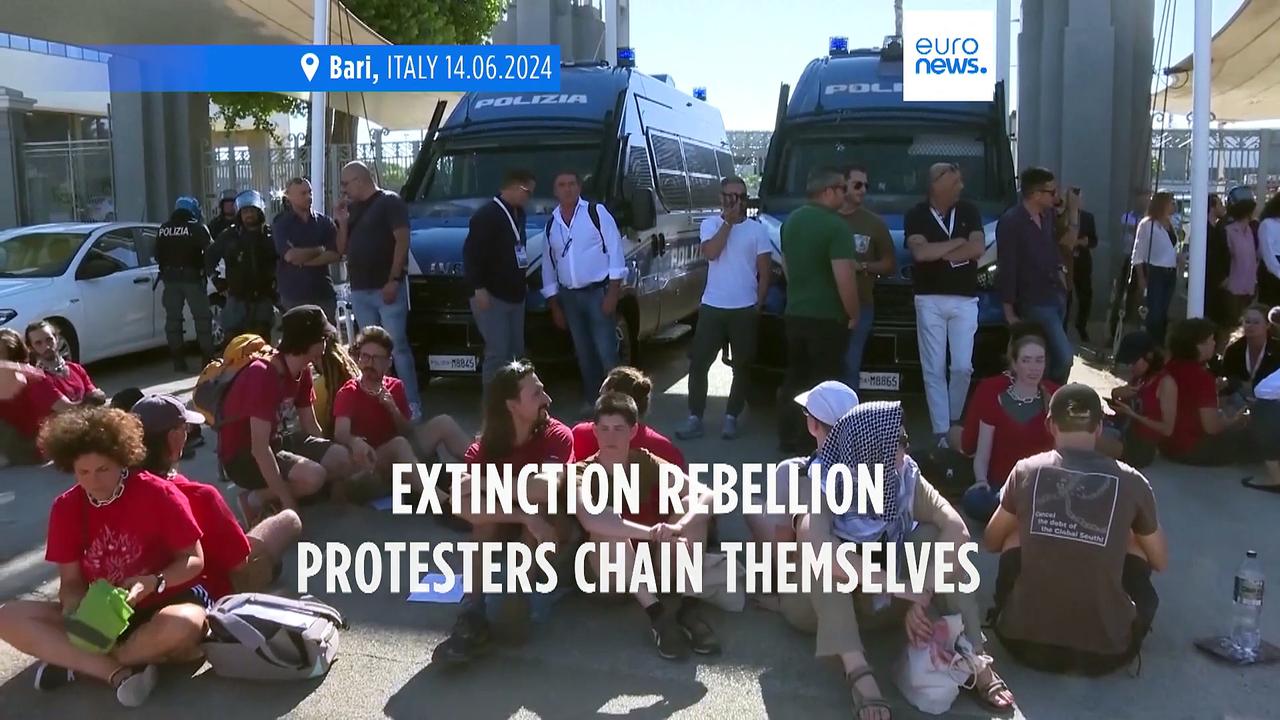 Extinction Rebellion protesters chain themselves up outside G7 summit