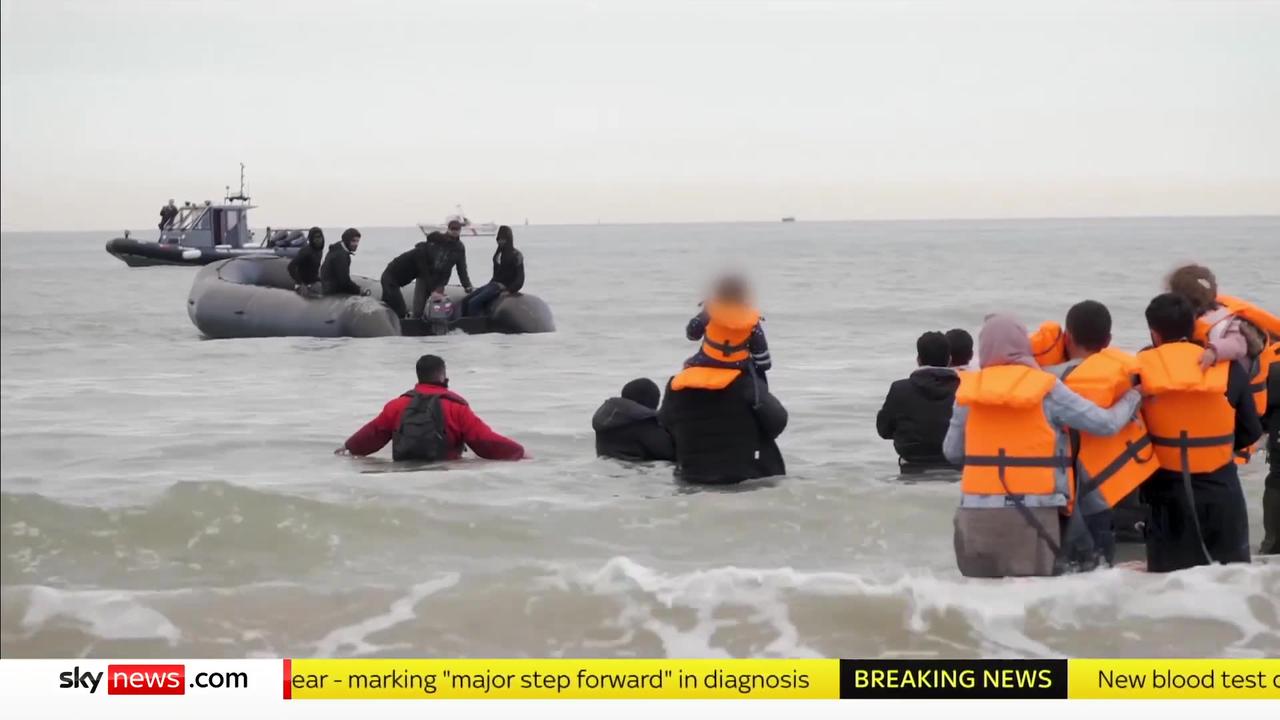 French police watch on as migrants attempt to board small boat to Britain
