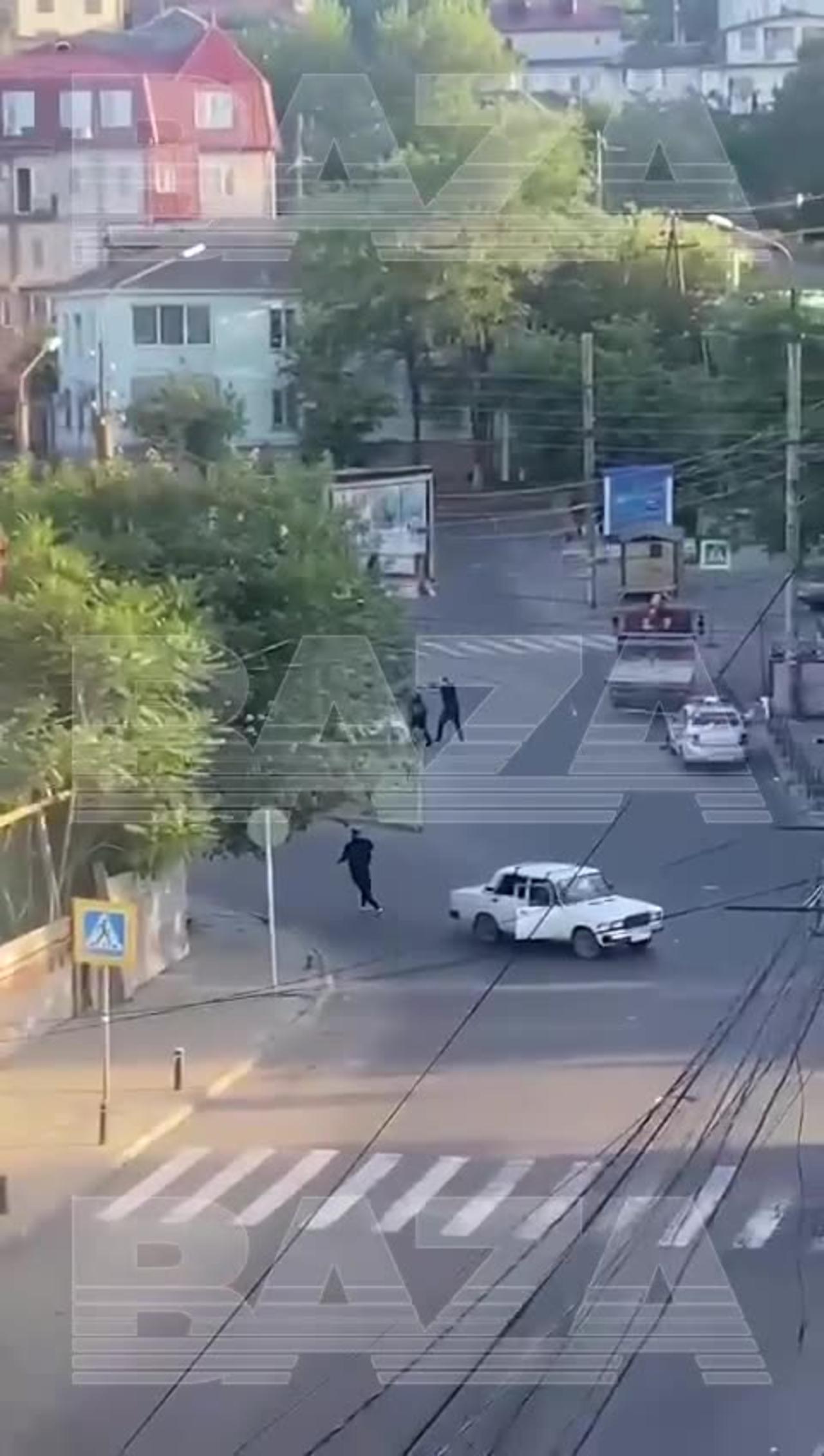 Shootout in Makhachkala, Russian Federation. Unknown men in black shooting at police cars.