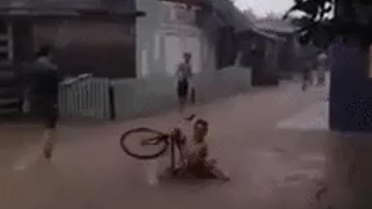 Funny fail man on a bike goes deep into a sea inmitten of the street