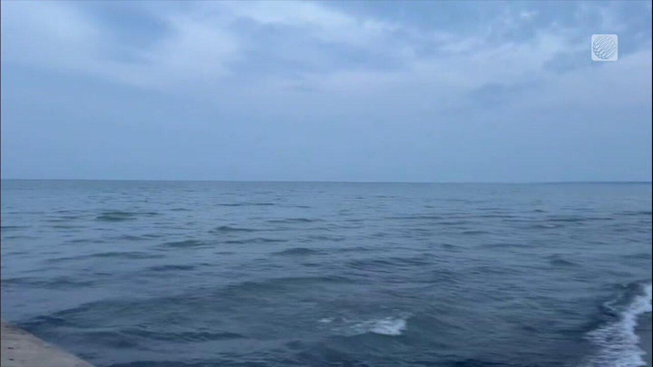 Rolling waves under some cloud cover along the shoreline of Lake Erie