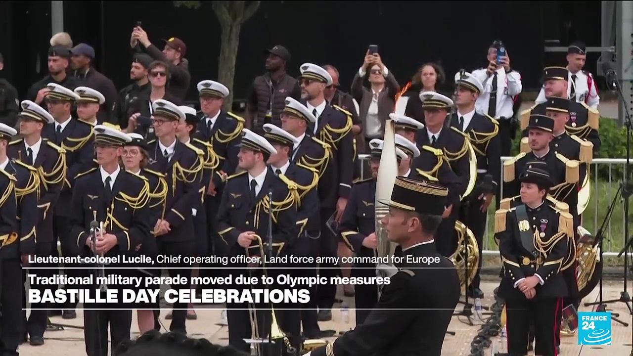 Bastille Day parade: Lieutenant Colonel Thibaut Vallette presents Olympic torch