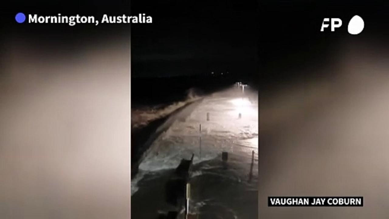 Huge waves crash onto pier as storm lashes Australia's southeast