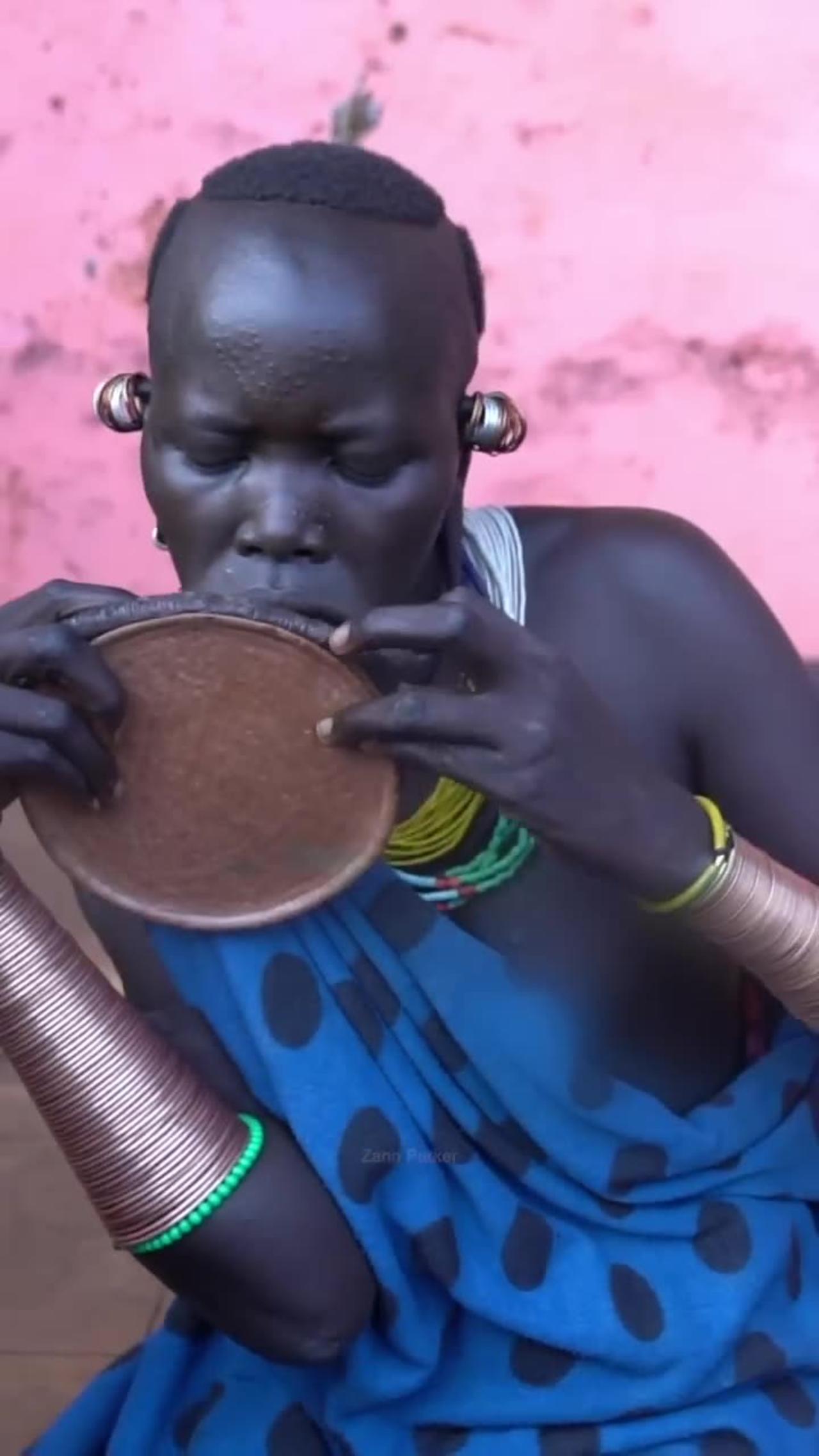 Woman from Surma Tribe Inserts Lip Plate | Omo Valley, Ethiopia