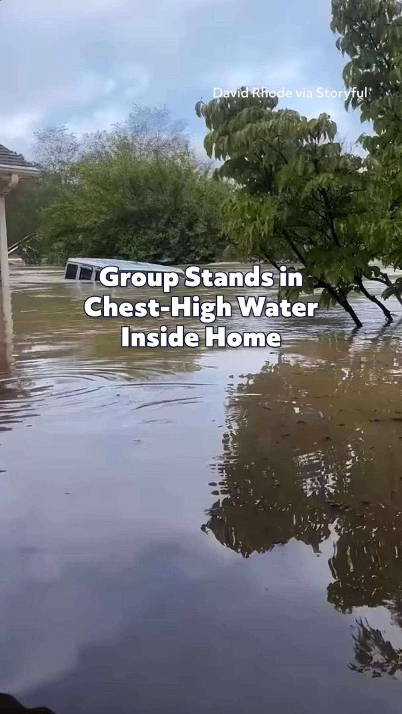 Group Stands in Chest-High Water Inside Home