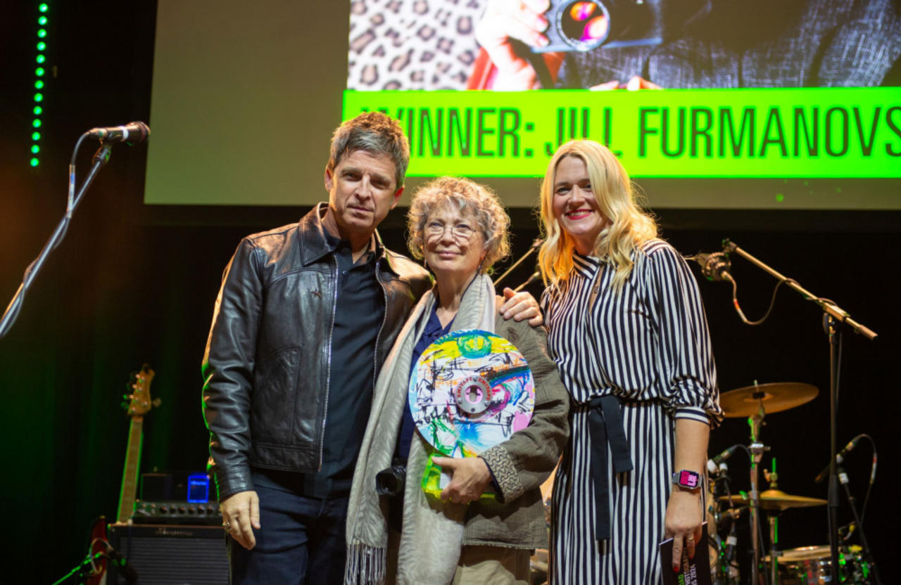 Noel Gallagher surprises  long-time Oasis photographer Jill Furmanovsky with an ICON Award at Abbey Road Music Photography Award