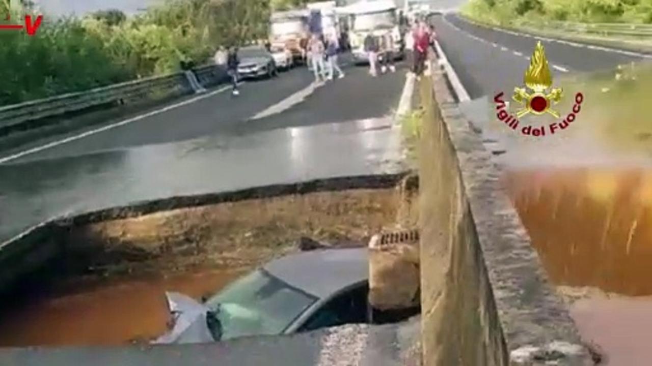 Car Swallowed by Giant Sinkhole in Flooded Italy