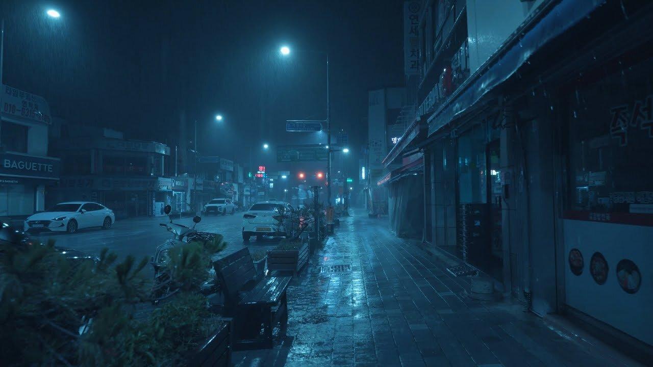 Empty night streets and city noises during heavy rain.