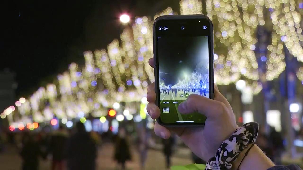 Crowds gather at Paris' Champs-Elysees for Christmas lights display