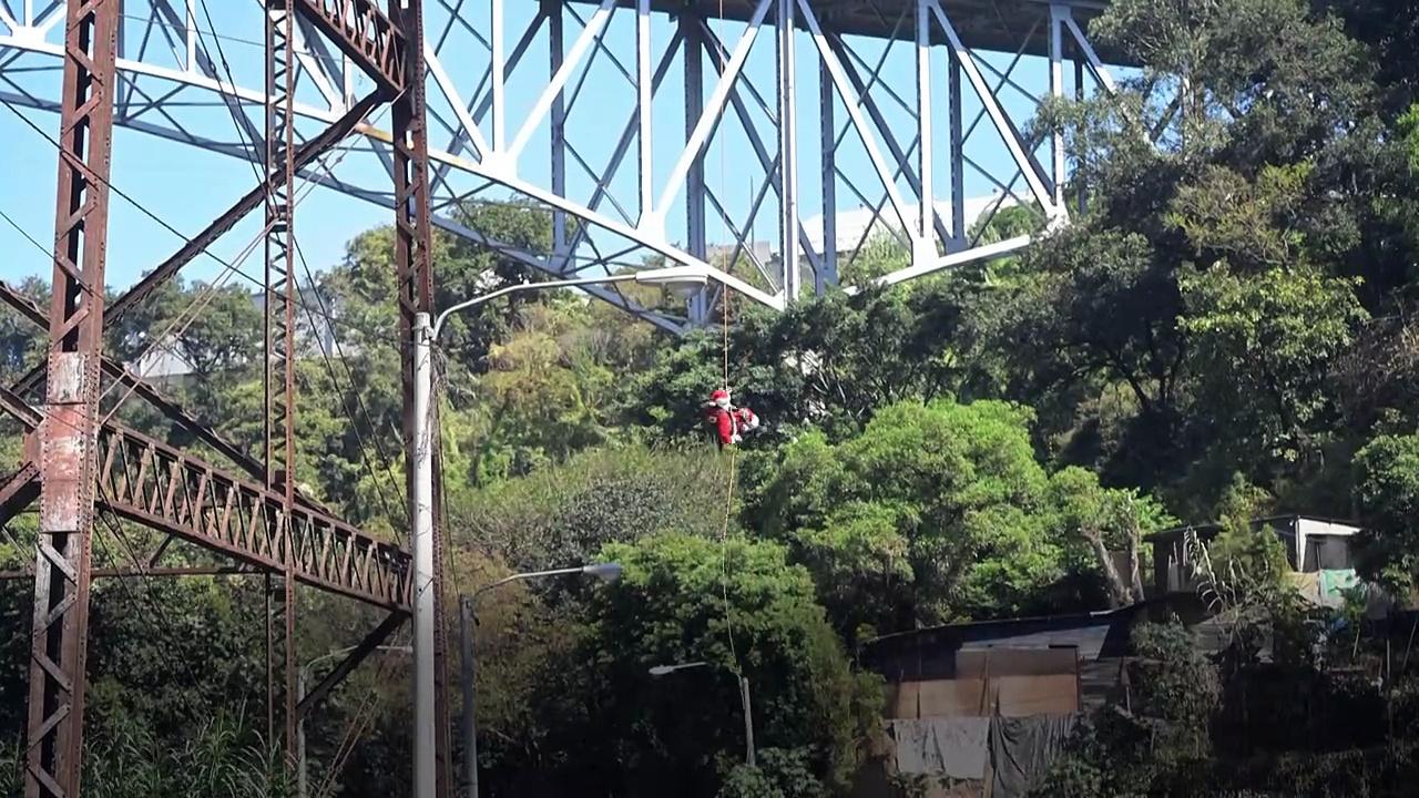 Guatemalan firefighter dressed as Santa delivers presents in low-income neighborhoods