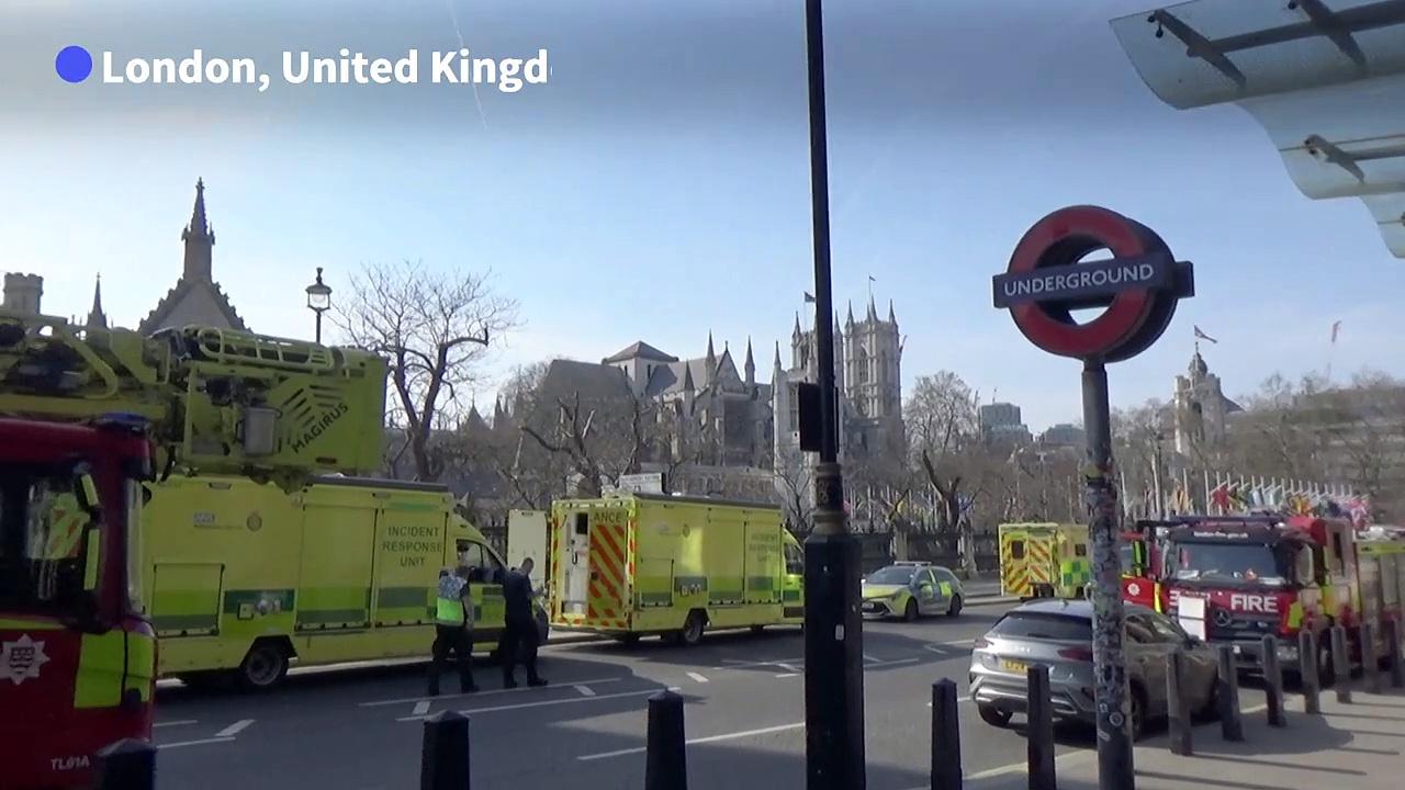 Man with a Palestinian flag perches on the side of Big Ben tower