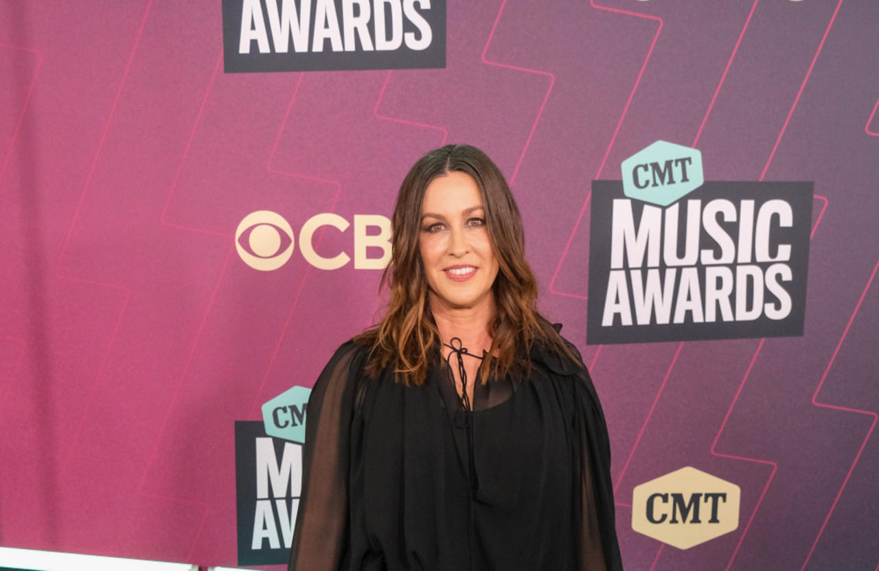 Alanis Morissette sees her long hair as a 'bandmate' because it helps her express herself on stage