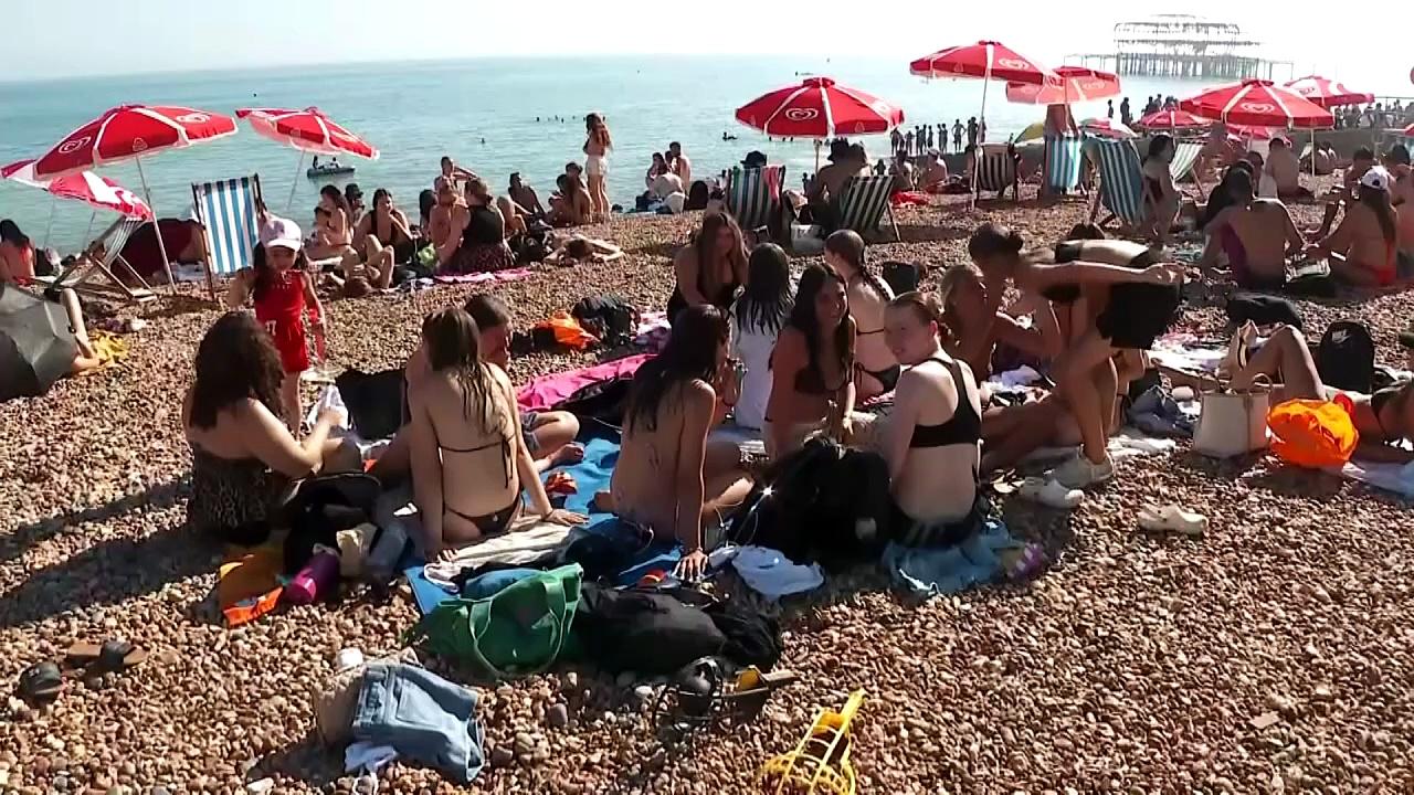 UK heatwave: Beachgoers in Brighton soak up sun