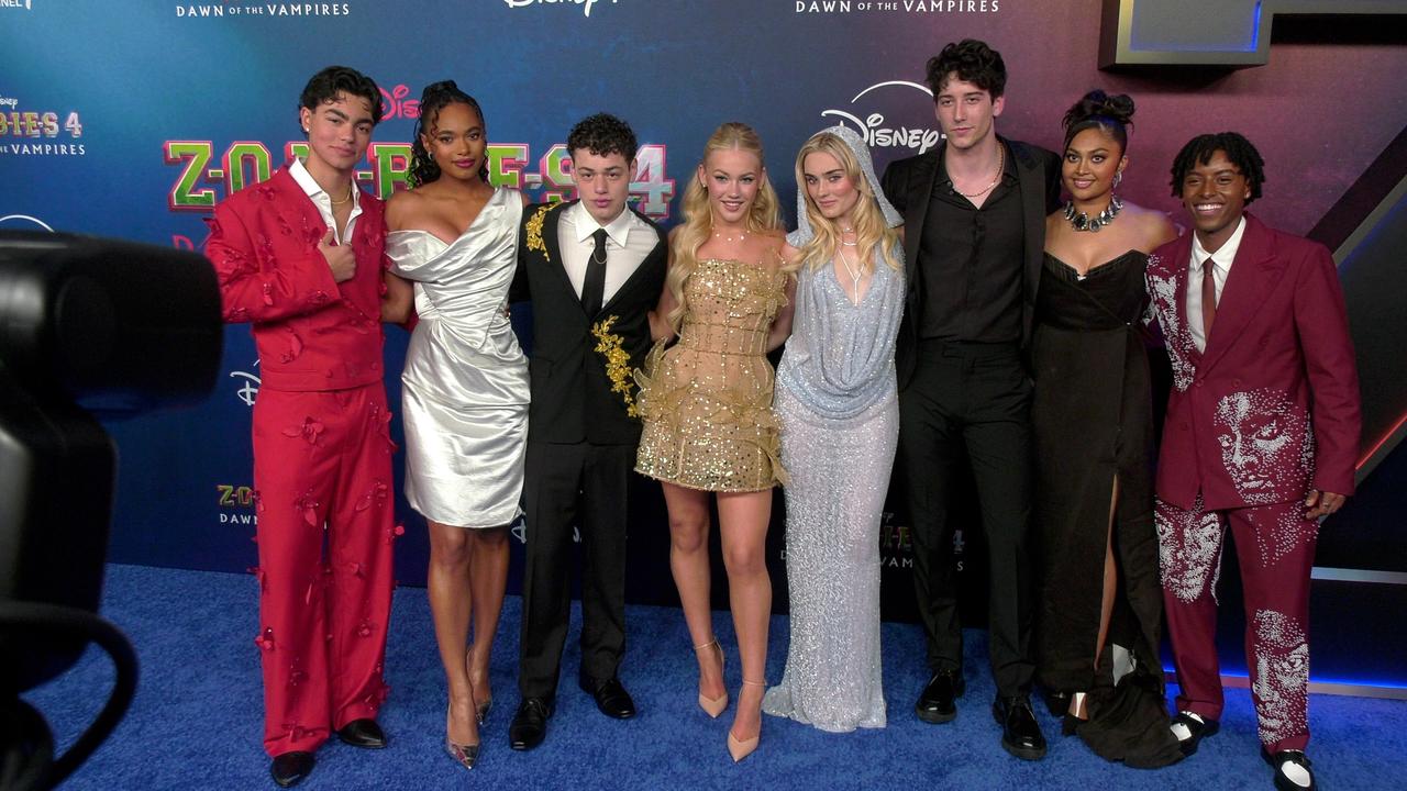 The cast of 'Zombies 4: Dawn of the Vampires' poses together at its premiere in Los Angeles