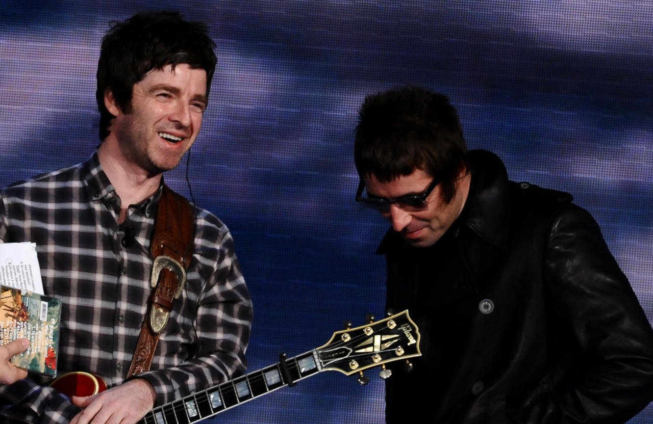 Oasis: Liam and Noel Gallagher use paper straws to warm up their vocals